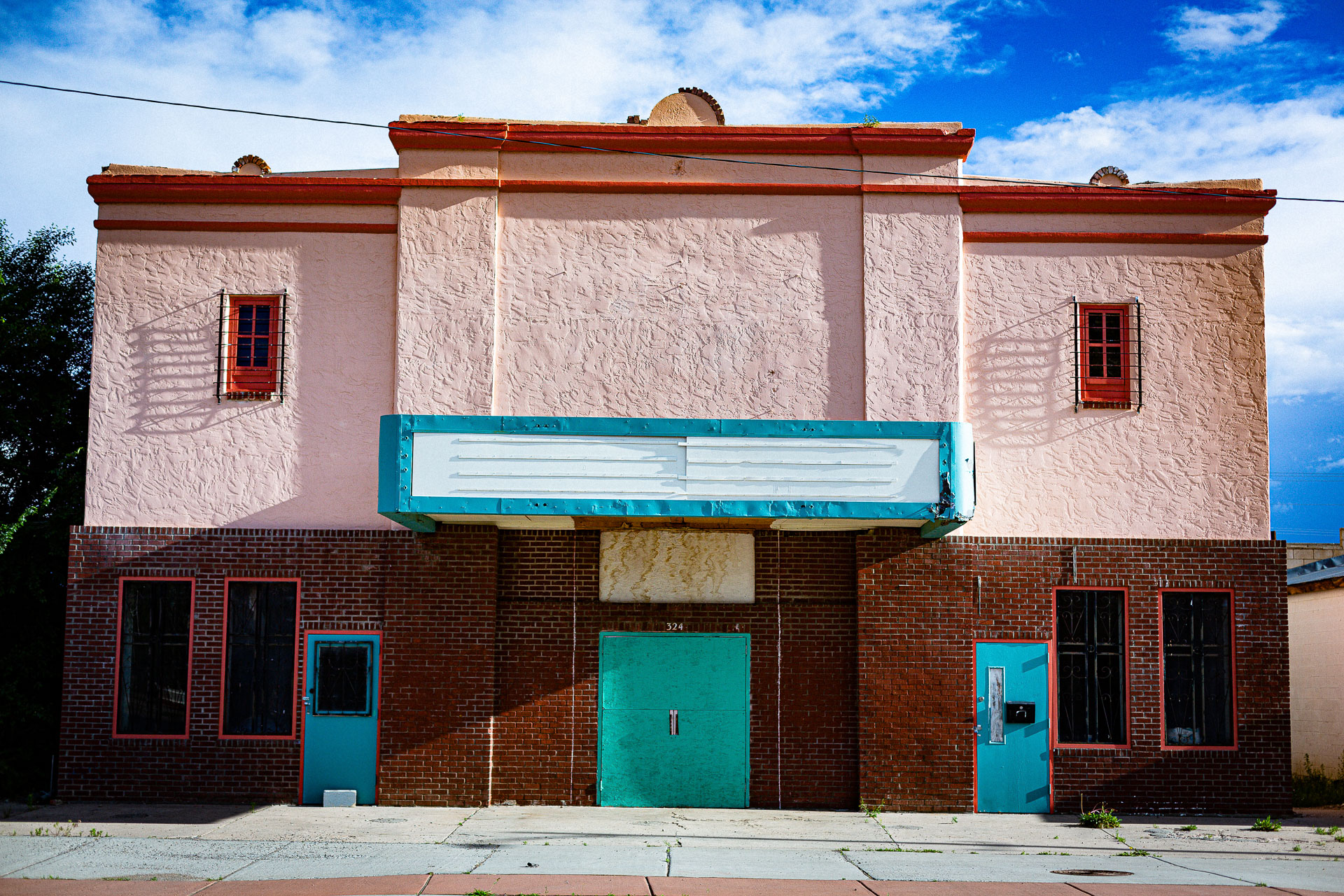 abandoned theater with bright blue doors.