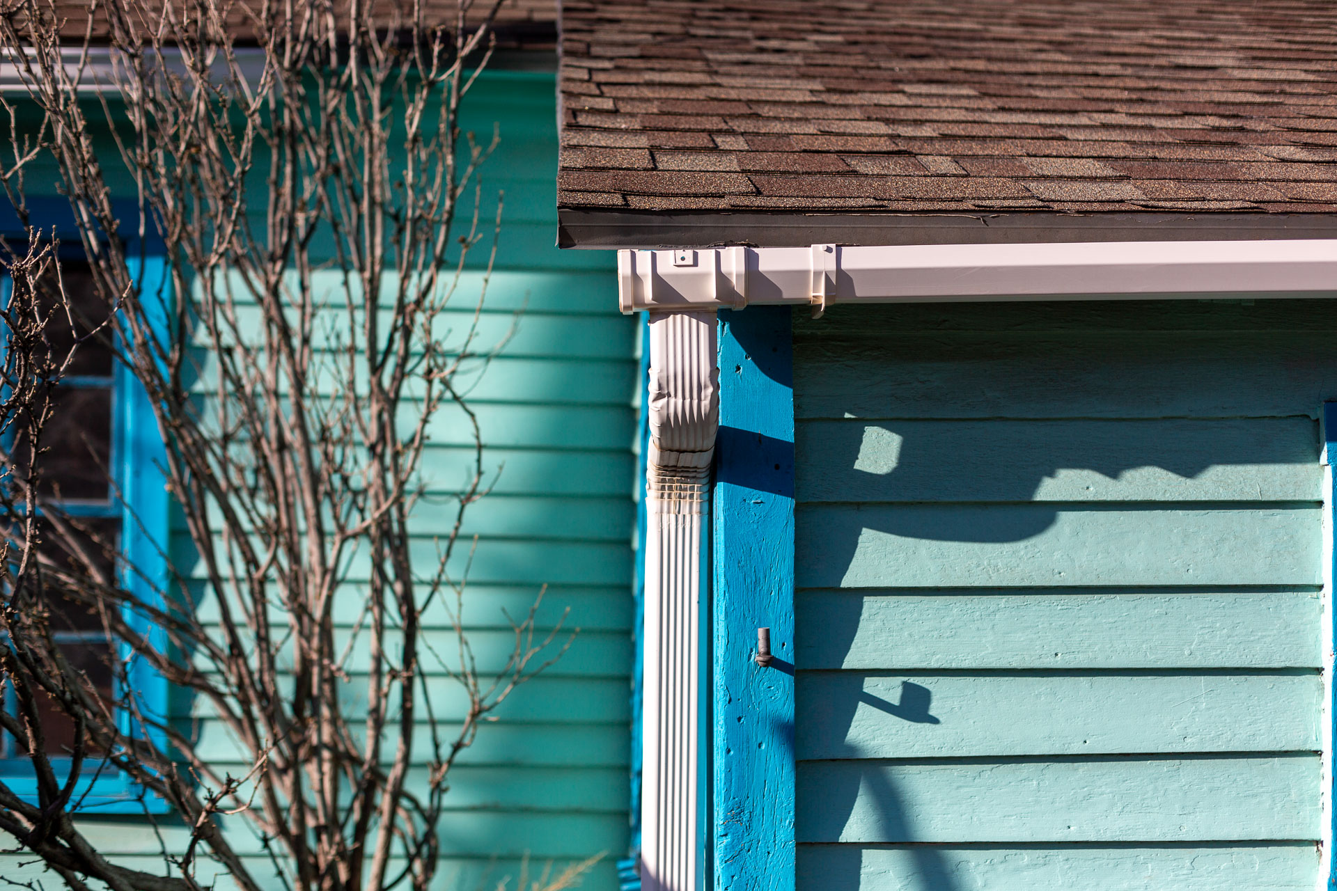 teal house with blue accents.