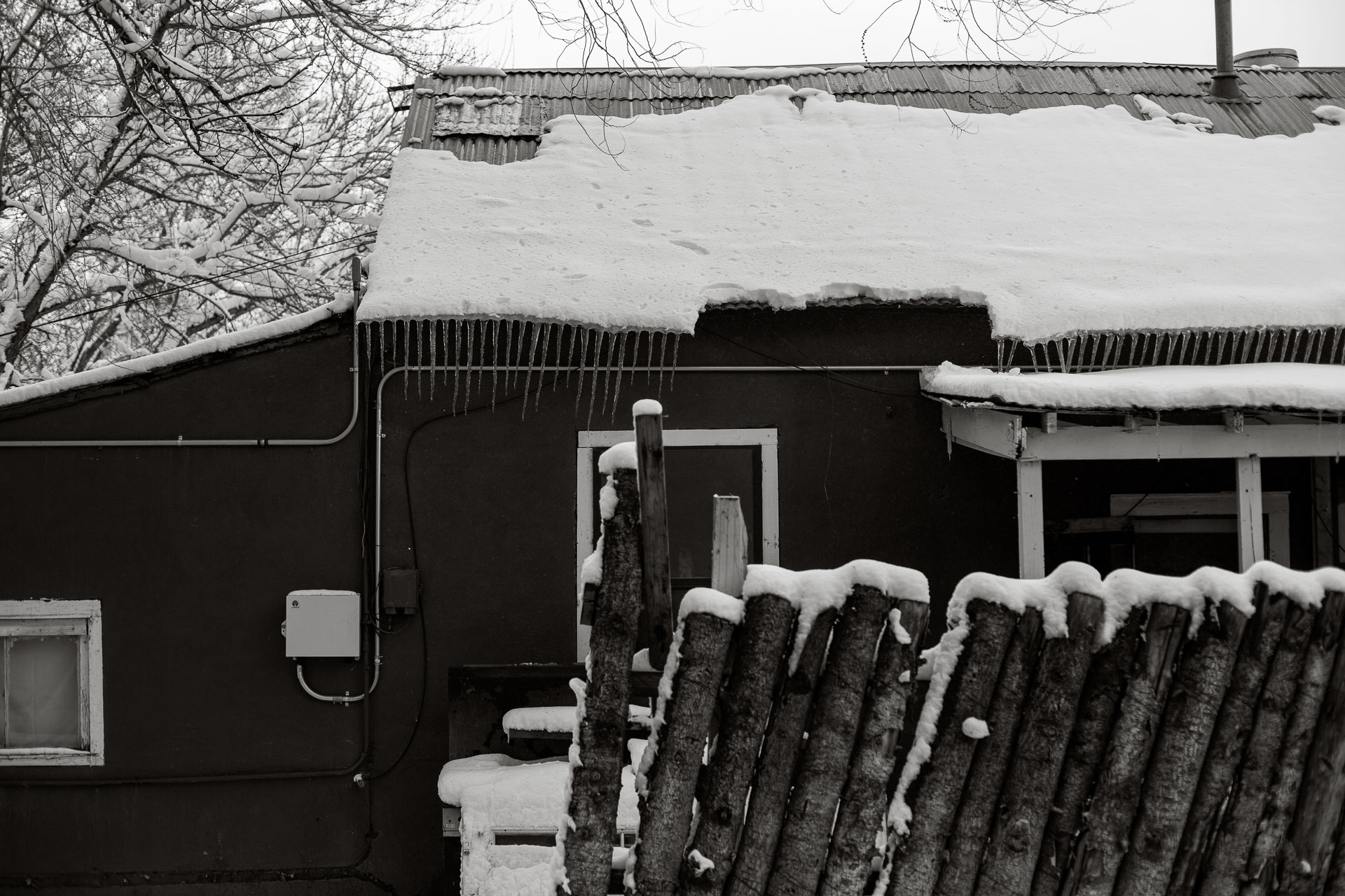 house with snow melting off of roof.