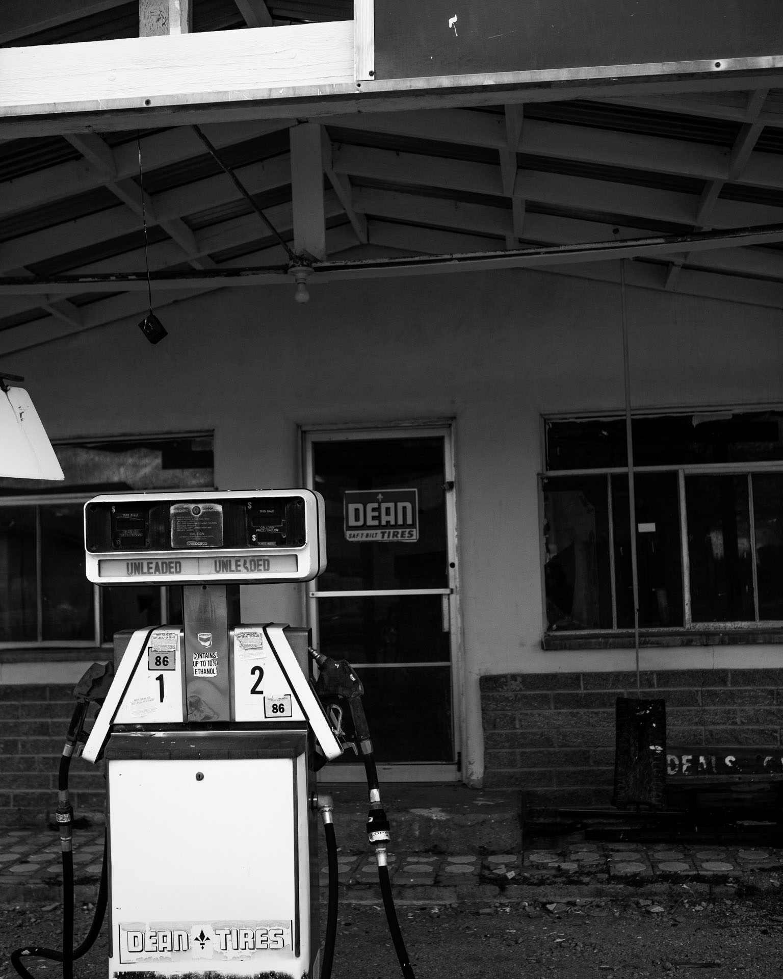 gas pump outside old gas station.