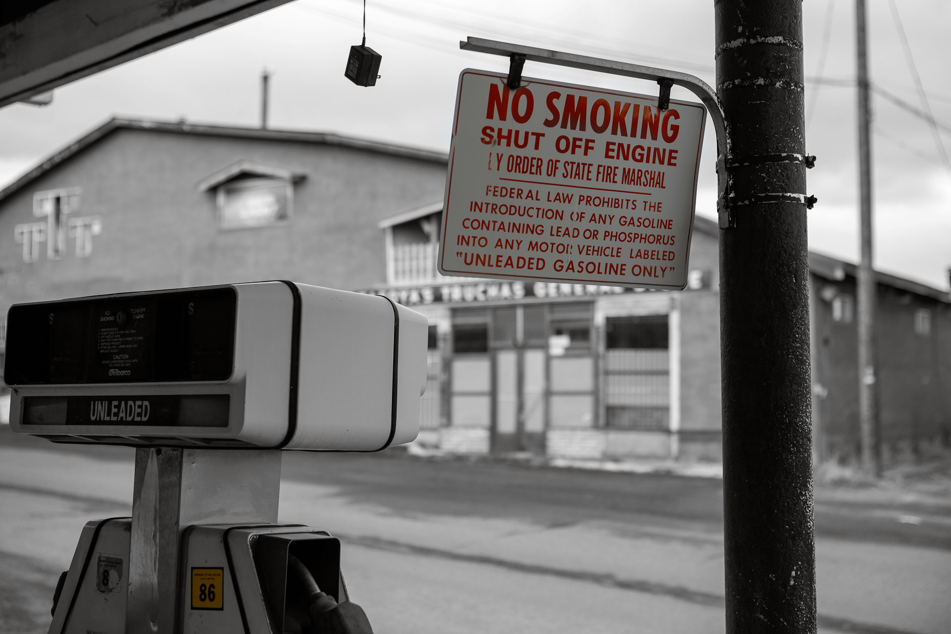 no smoking sign next to gas pump.