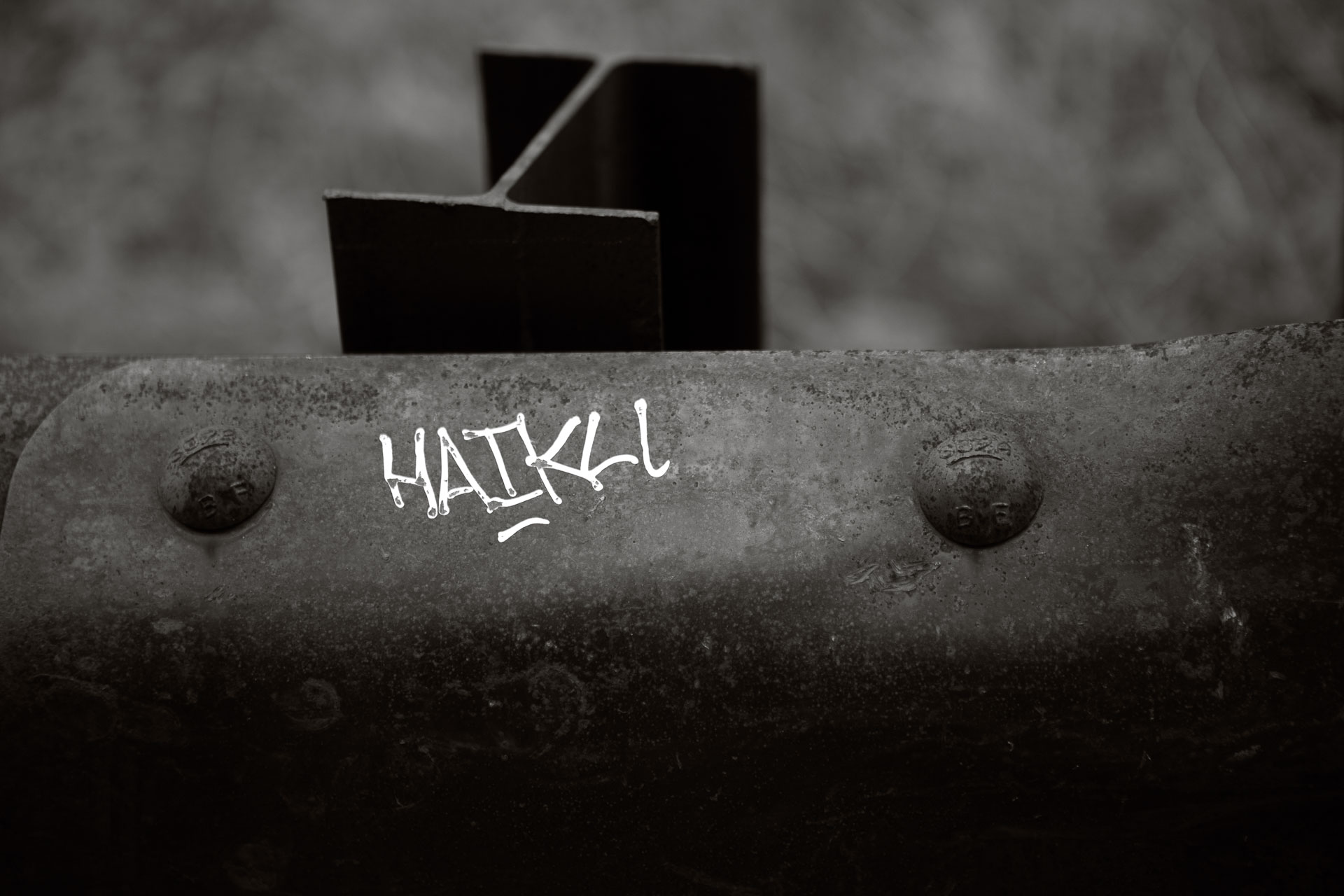 small writing on old guard rail.