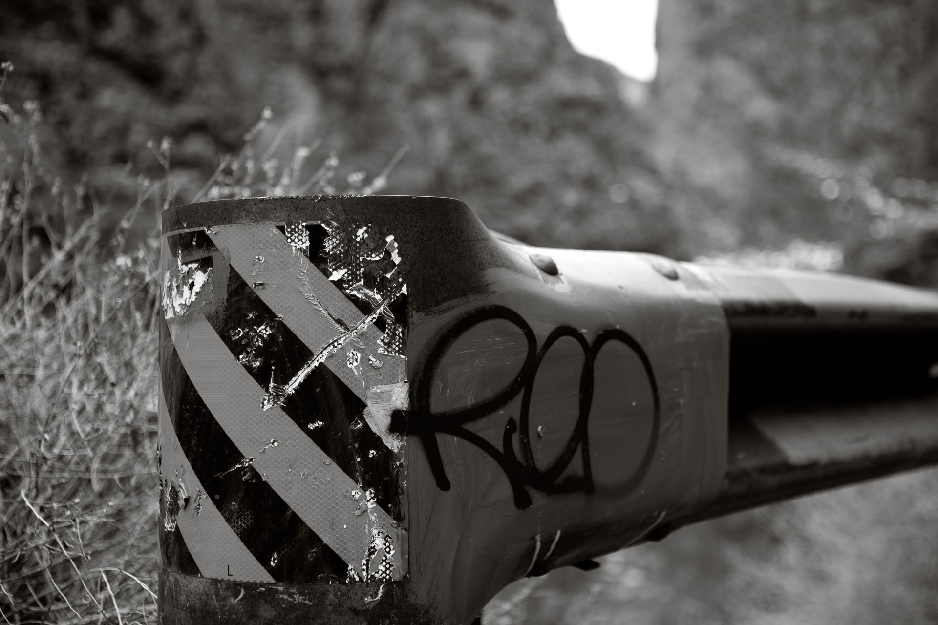 graffiti on old guard rail.