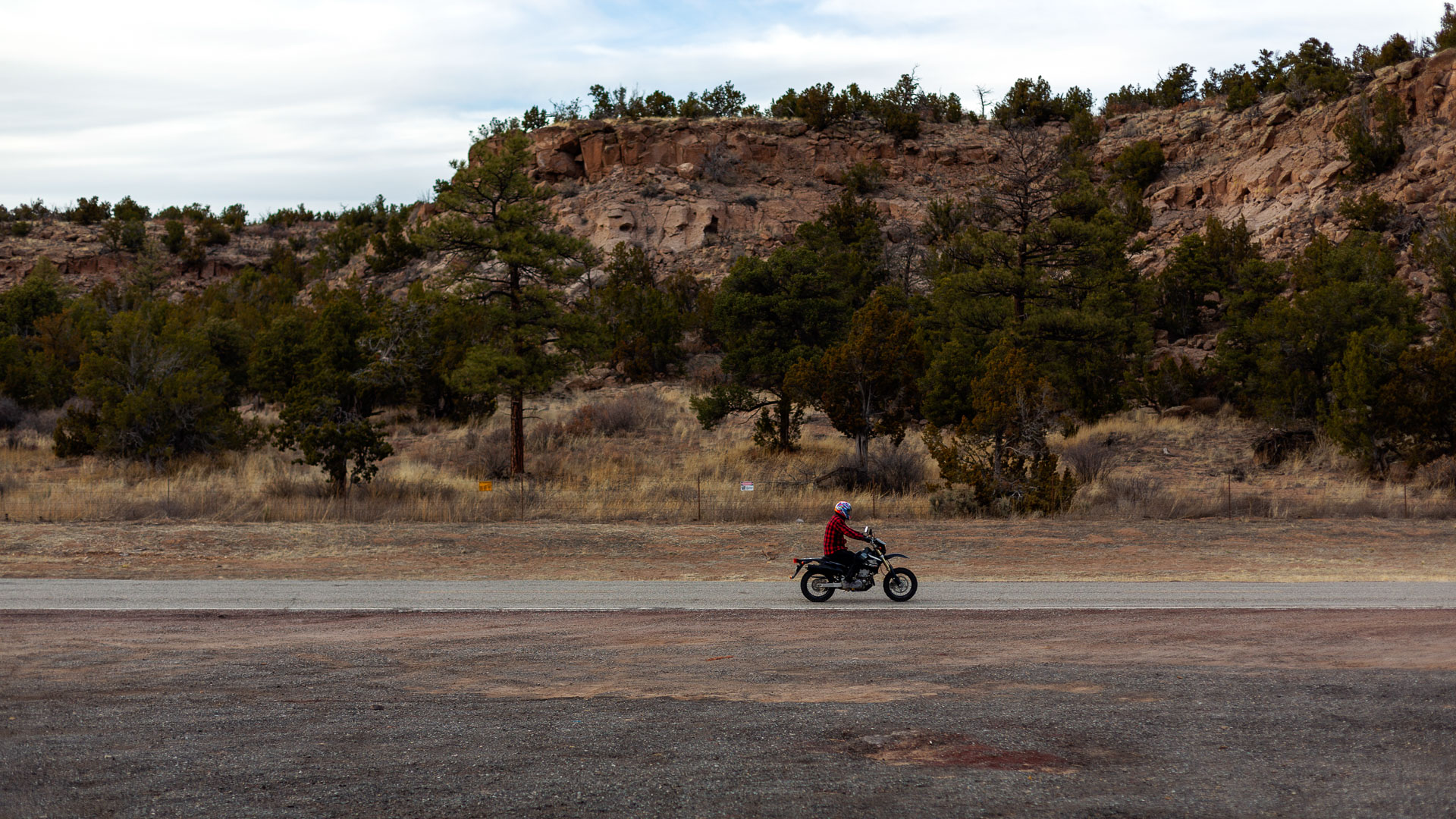 motor bike driving past mountain landscape.